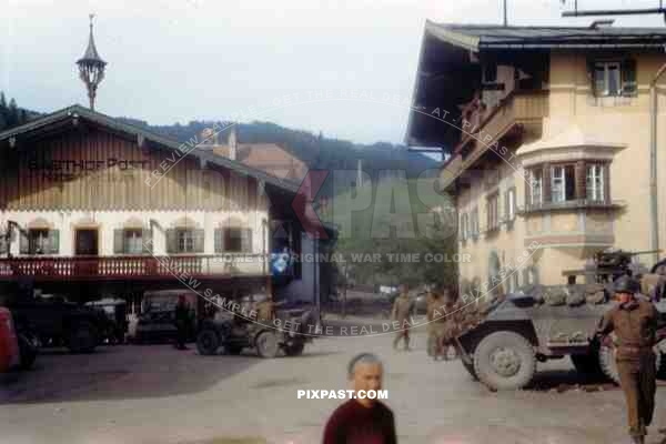 American armoured cars of the 101st Cavalry Regiment park opposite SS troops in Kossen Austria 1945.