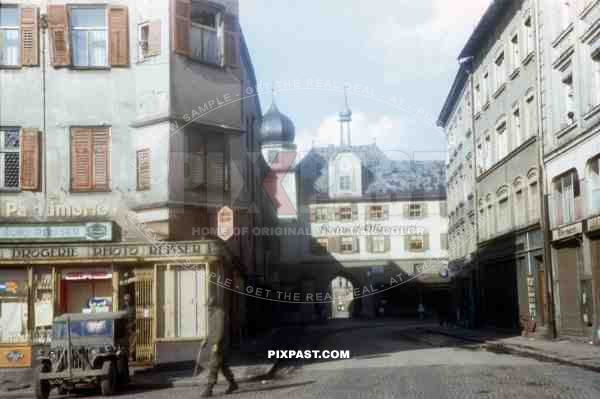American Willy Jeep parked in front of Camera Shop. Mittertor Rosenheim Bavaria 1945. 101st Cavalry Regiment