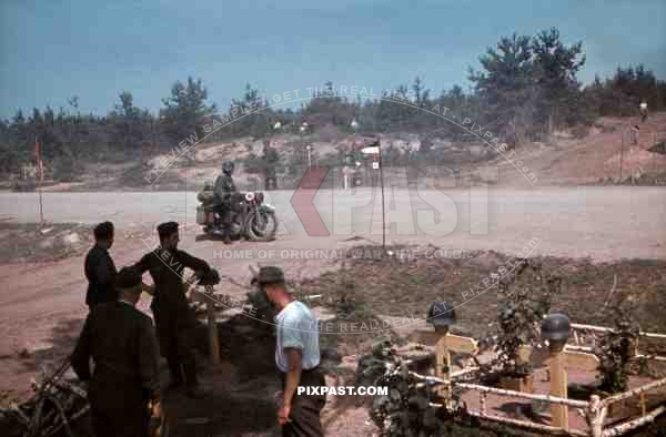 Feldgendarmerie field police with Gorget on motorbike, Cross roads army graveyard with helmets, 19th Panzer Division, 1941