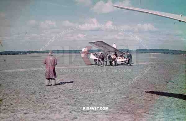 German Luftwaffe engineer watches hitler youth transport glider plane in Lubeck airport 1943