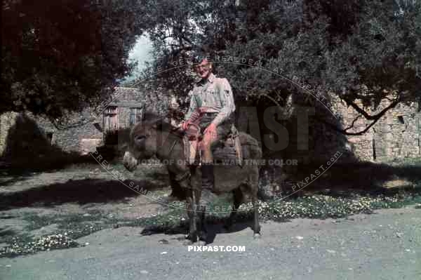 German Luftwaffe flak soldier riding donkey in Village, Kreta Crete 1942.
