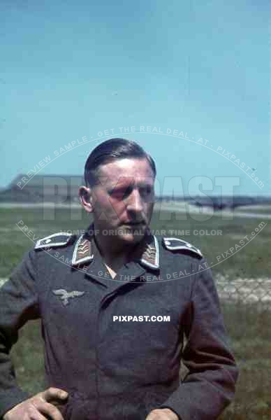 German Luftwaffe Ground Crew summer 1941 airbase with landing aircraft, portrait.