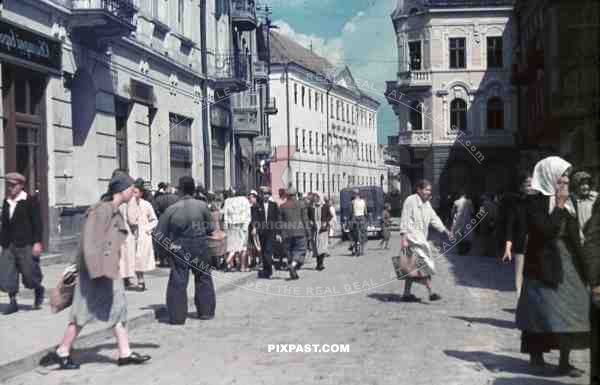 German Military ambulance drives through busy populated town in Ukraine 1942 shops peasants