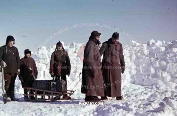 German Wehrmacht soldiers infantry pulling snow sled with food and ammunition in snow field Finland 1943