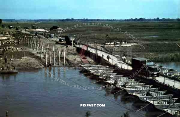 Germany army supply trucks driving over a make-shift pontoon bridge on the river Bug. 94. Infantry Division. Russia 1941