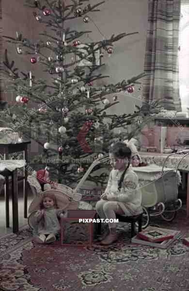 little girl sitting under the christmas tree, Germany 1939