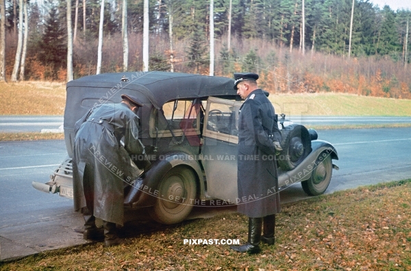 Luftwaffe driver pouring petrol into staff car on their way to Stuttgart on the autobahn. Germany 1940