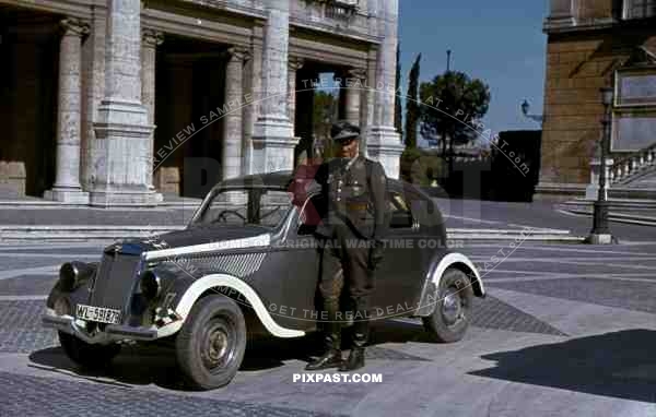 Luftwaffe flak officer of the Leichte Flak Abteilung 99 (mot) in Rome Italy 1944 with staff car.