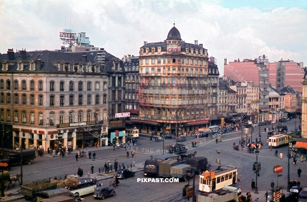 Market place in Brussels Belgium 1940. Market filled with buses, trams and trams. Cecil Hotel.