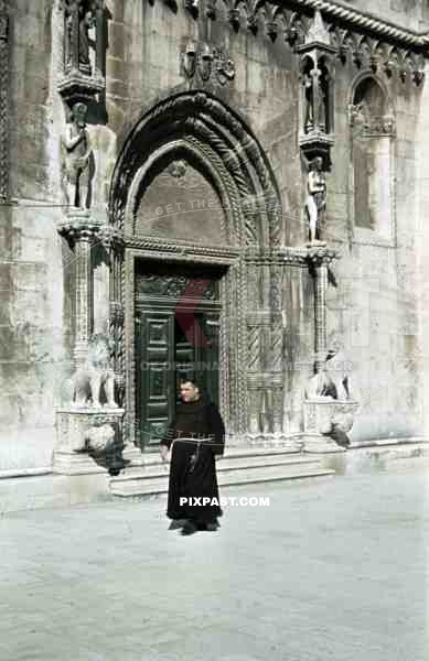 monk in front of St. James cathedral in Sibenik, Croatia