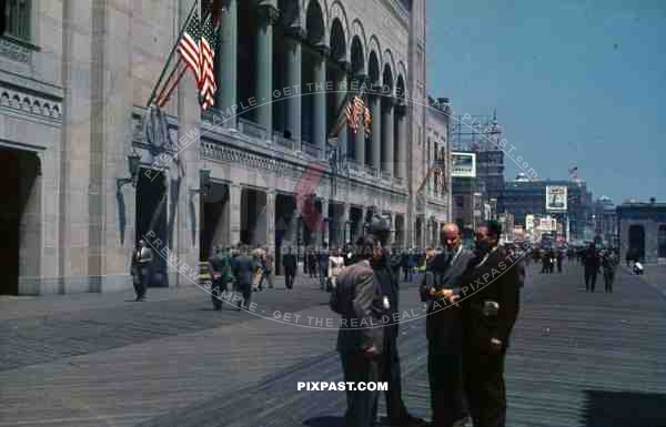 PostW color 1947 New York board walk shops bank american flag german tourists