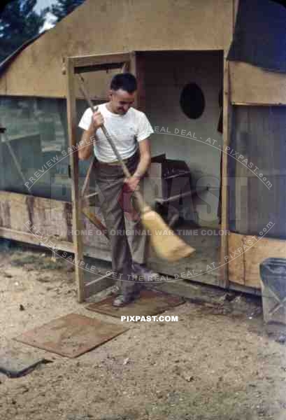 Sweeping in front of the barracks in Okinawa, Japan 1946