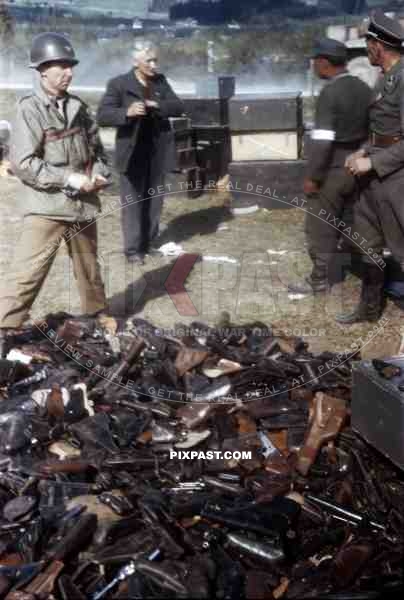 Waffen SS Officers surrender pistols to American officer of the 101st Cavalry Regiment. Schwendt Austria 1945