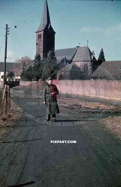 Wehrmacht soldier in front of St. Baptist church in NiederauÃŸem, Germany 1940