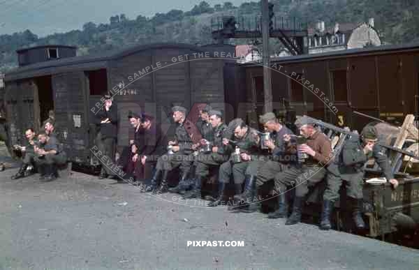 Wehrmacht train station transport Belgium 1940, eating soup in canteen, carriages, Jewish David star on carriage,