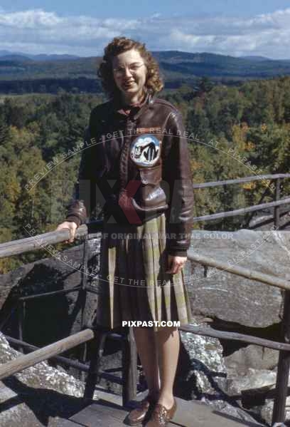 wife of a USAAF pilot wears proudly her mans Air Force jacket with Unit Patch. Dated USA 1942.