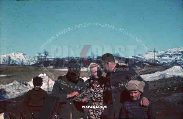 WW2 Color Norway German radio operator with medals and artillery soldier camera listen to Gramophone music with civilians 1941