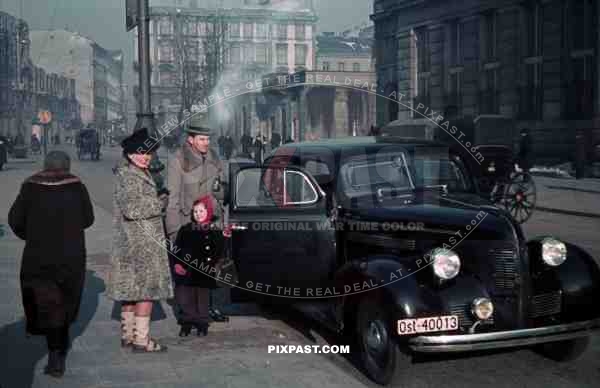 WW2 color Warsaw Ghetto German Business man with family car camera OST 1939 Poland winter city horse wagon