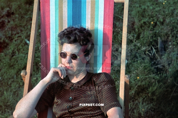 Young Austrian women wearing sun glasses relax in sun chair. Austria 1939
