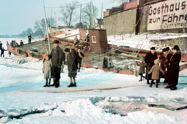 Father with his daughter on a frozen Elbe river beside a frozen car ferry. Gasthaus zur Fahre Curt Streidl. Dresden 1940