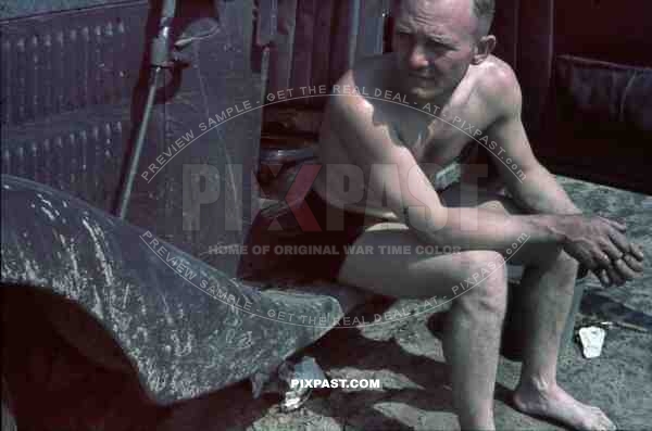 German army driver resting beside Mercedes Staff car on Dusty Russian Roads. Summer 1941. 4th Panzer Division.