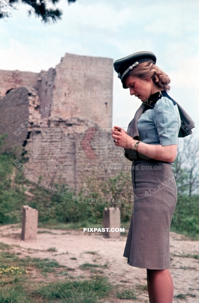 Young attractive wife of a infantry Wehrmacht officer wearing his army Peaked cap Schirmmutze. Lindau Germany 1944
