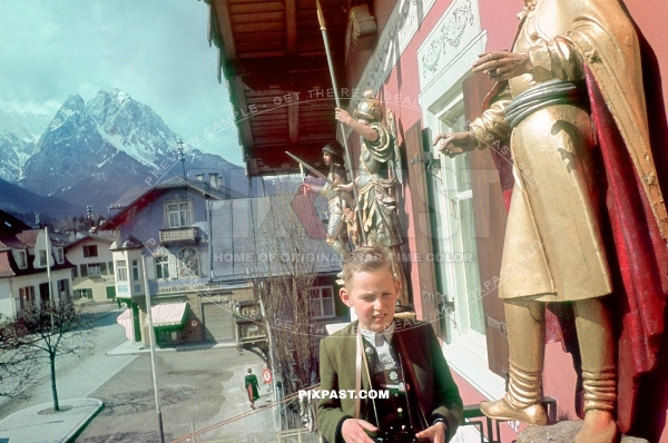 Young boy in Bayerische Tracht, binoculars on the balcony of Atlas Post Hotel. Garmisch Partenkirchen Bavaria Germany 1939